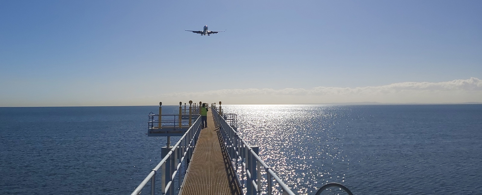 HIAL Jetty with plane overhead at Brisbane Airport