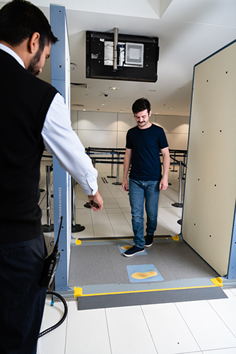Person using body scanner at Brisbane Airport
