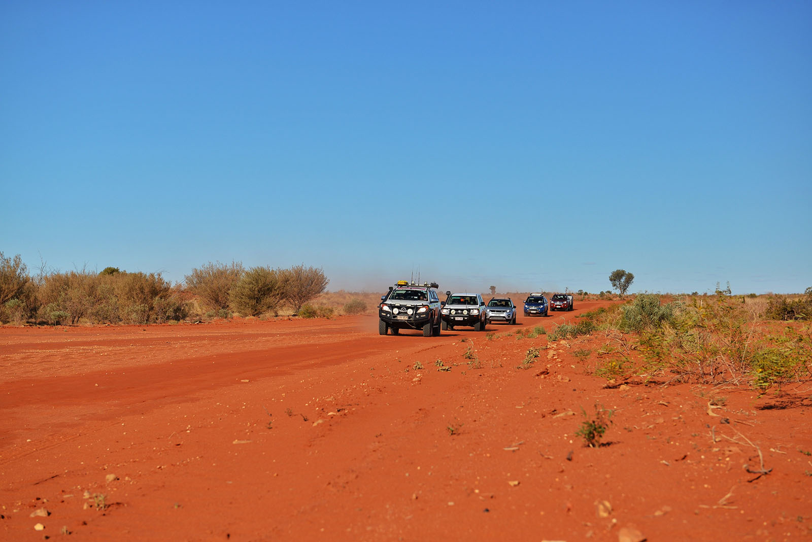 A convoy of cars through the outback | A bird's eye view of Birdsville